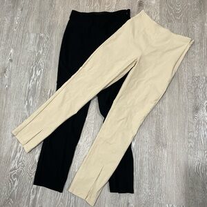 Cream and black straight leg trousers with slit at bottom ankles